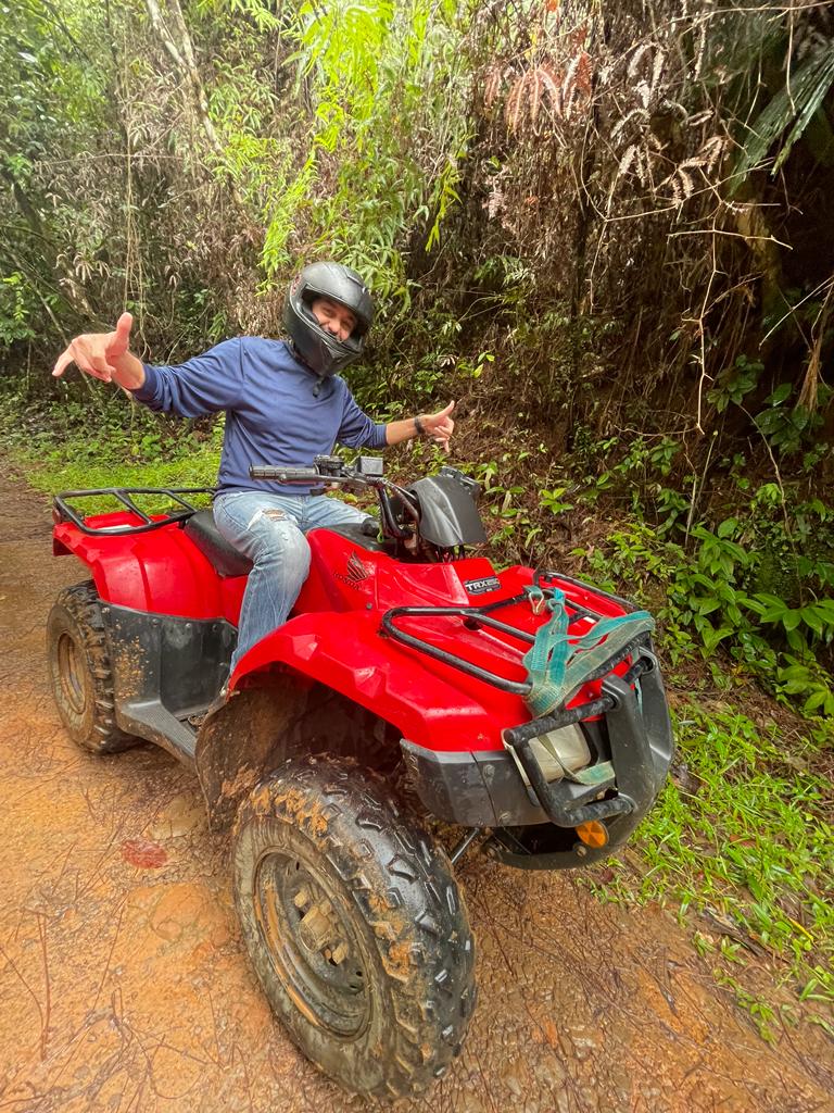 Rider on a red ATV on a jungle trail in Cerro Azul