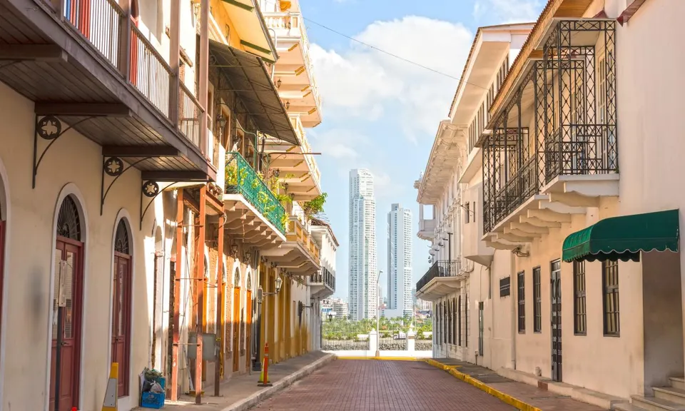 Colonial street in Casco Viejo with the Panama City skyline behind
